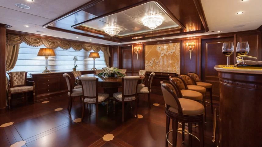 a large room with a table and chairs aboard INCAL Yacht for Sale