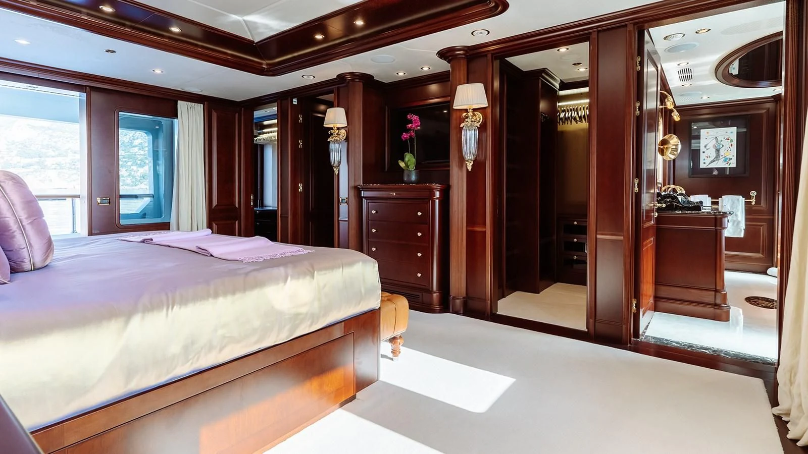 a bedroom with a bed and a mirror aboard INCAL Yacht for Sale