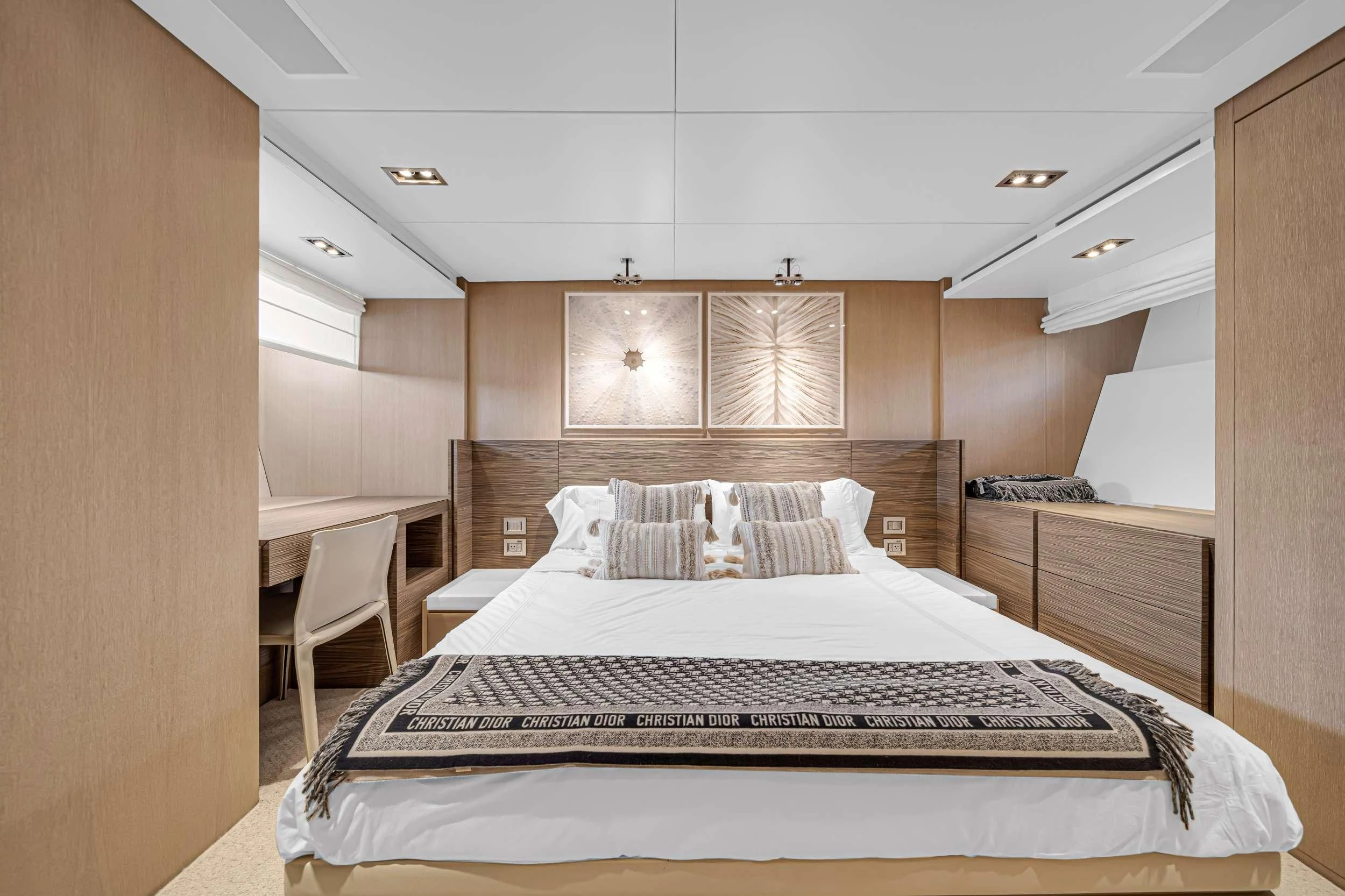 a bedroom with a bed and a chair aboard ASTONISH Yacht for Sale