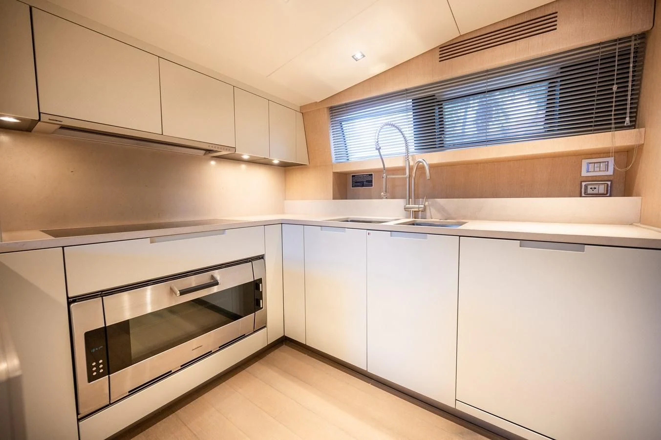 a kitchen with white cabinets aboard ASTONISH Yacht for Sale