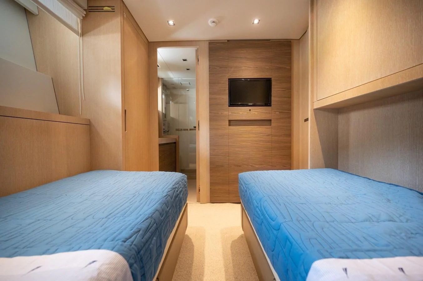 a room with a bed and a television aboard ASTONISH Yacht for Sale