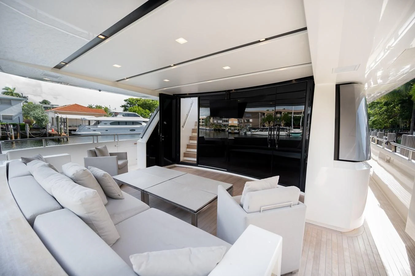 a living room with a large balcony aboard ASTONISH Yacht for Sale