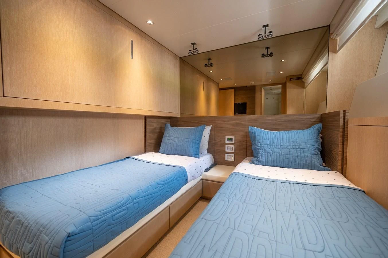 a room with beds and a couch aboard ASTONISH Yacht for Sale