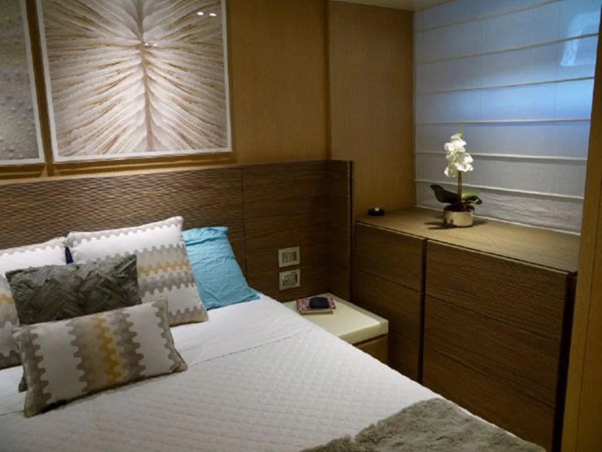 a bed with pillows and a white pillow aboard ASTONISH Yacht for Sale
