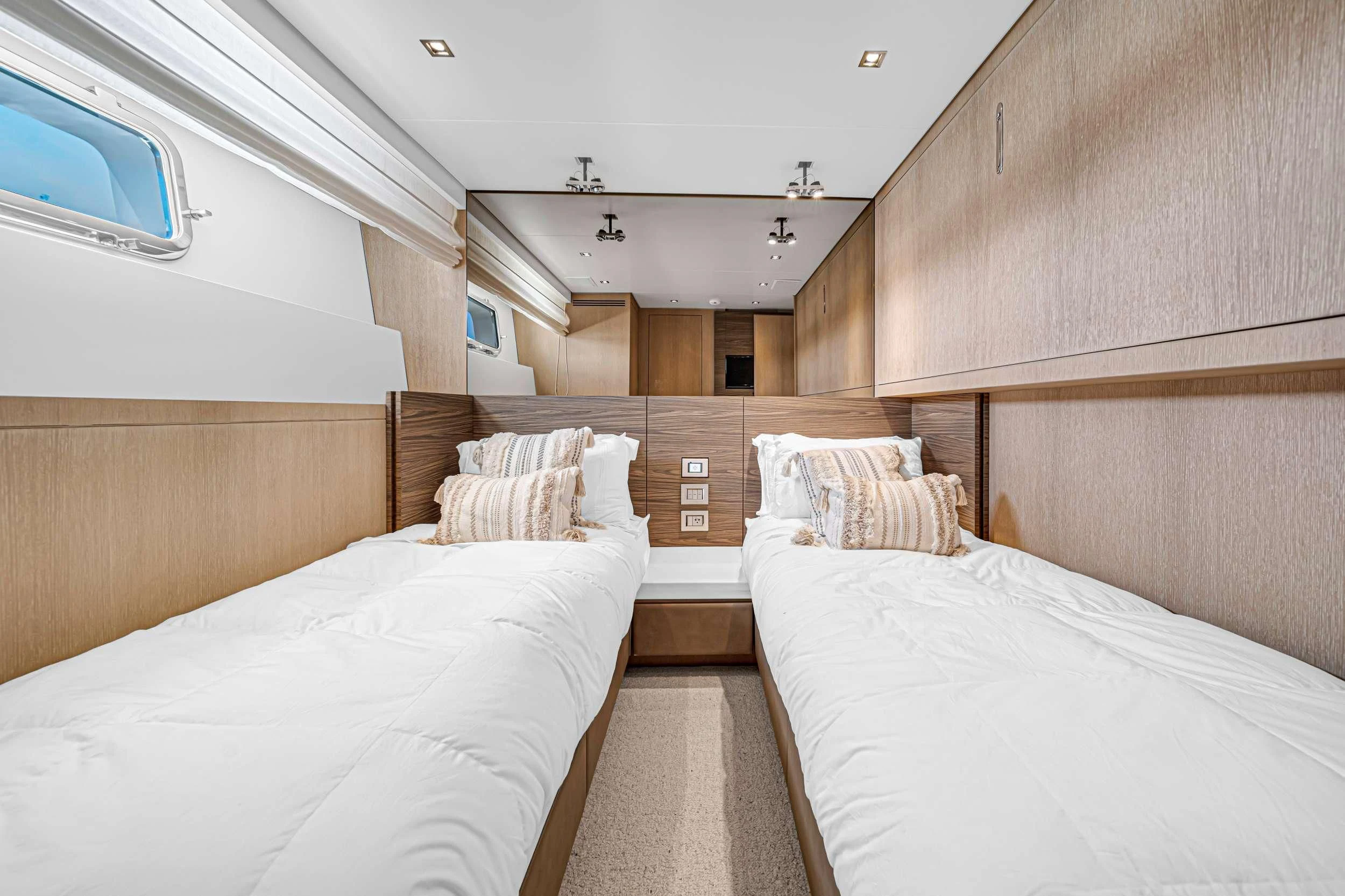 a room with a bed and a window aboard ASTONISH Yacht for Sale