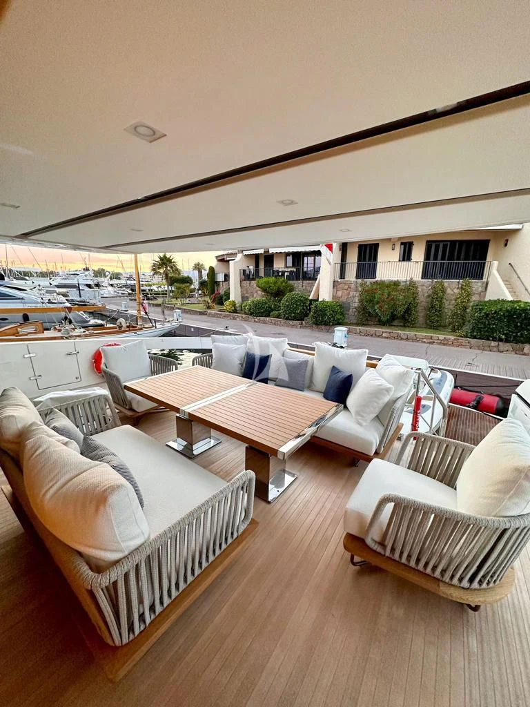 a deck with couches and a pool aboard BELLE DE NUIT Yacht for Sale