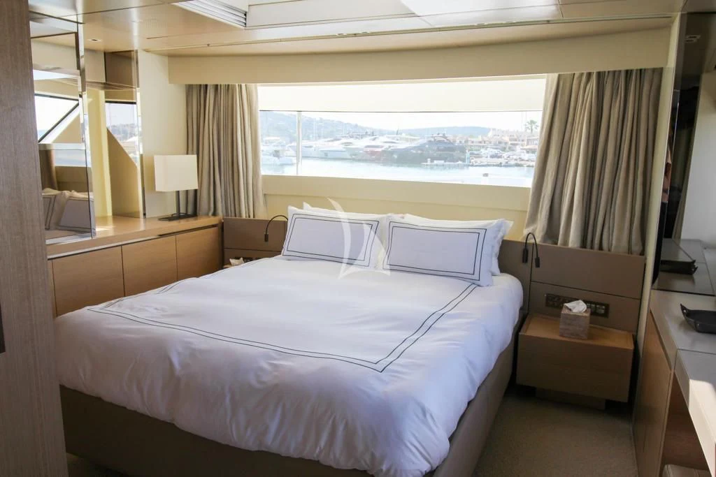 a room with a bed and a window aboard BELLE DE NUIT Yacht for Sale