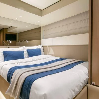 a bed with blue sheets aboard BELLE DE NUIT Yacht for Sale