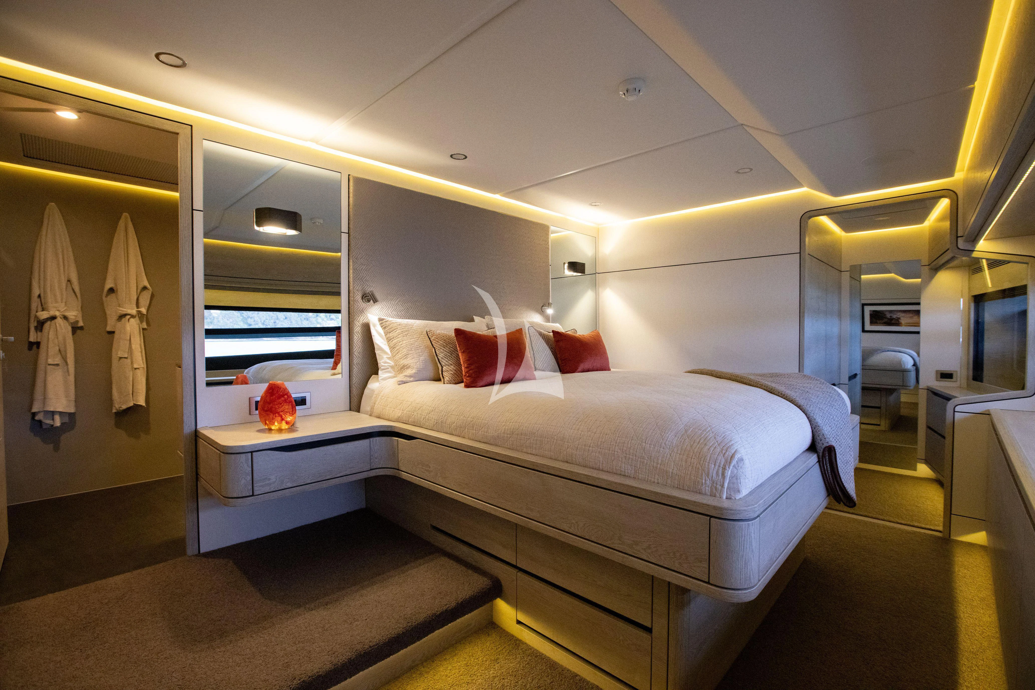 a room with a bed and a mirror aboard RUA MOANA Yacht for Sale