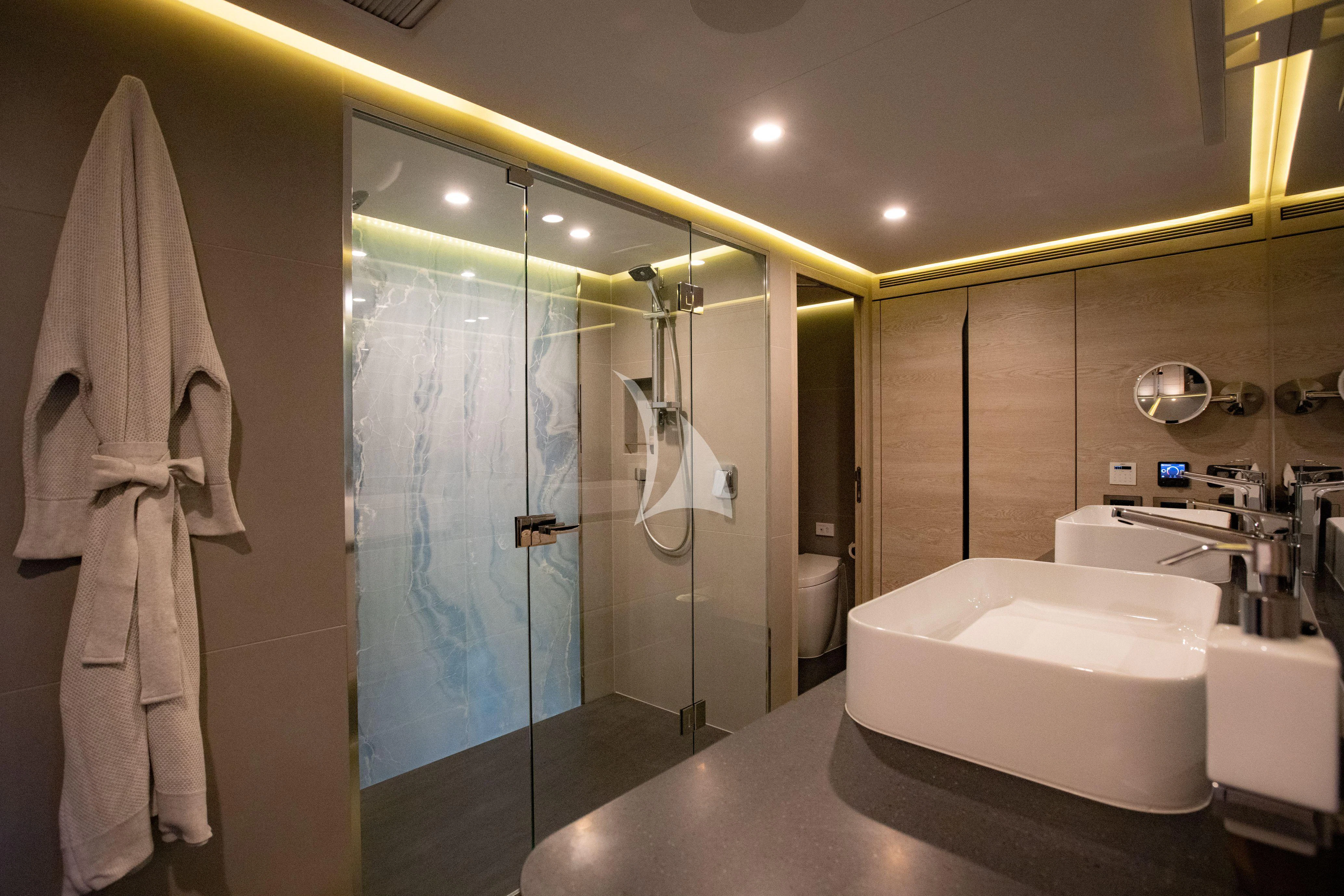 a bathroom with a glass shower aboard RUA MOANA Yacht for Sale