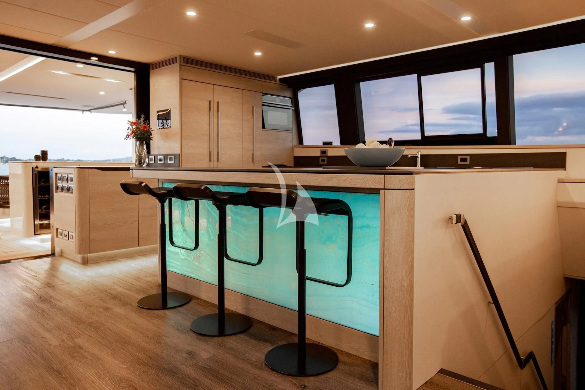 a large kitchen with a table and chairs aboard RUA MOANA Yacht for Sale