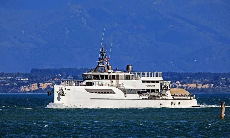 a large white boat in the water aboard PURSUIT Yacht for Sale