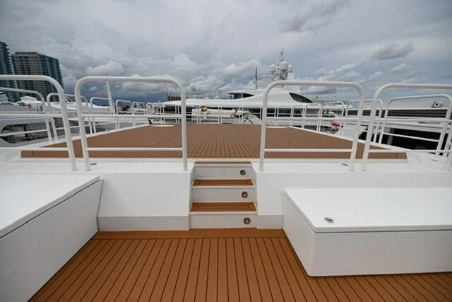 a deck with a railing and a view of a city aboard PURSUIT Yacht for Sale