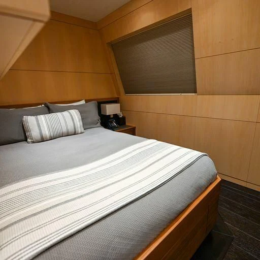 a bed with white sheets aboard PURSUIT Yacht for Sale