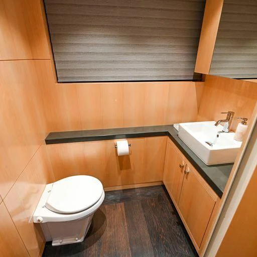 a bathroom with wooden walls aboard PURSUIT Yacht for Sale