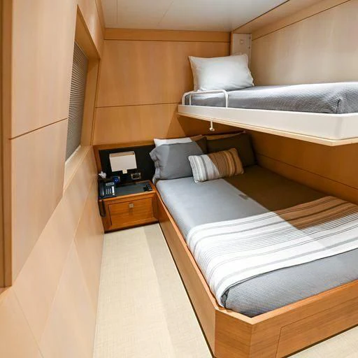 a room with beds and a desk aboard PURSUIT Yacht for Sale