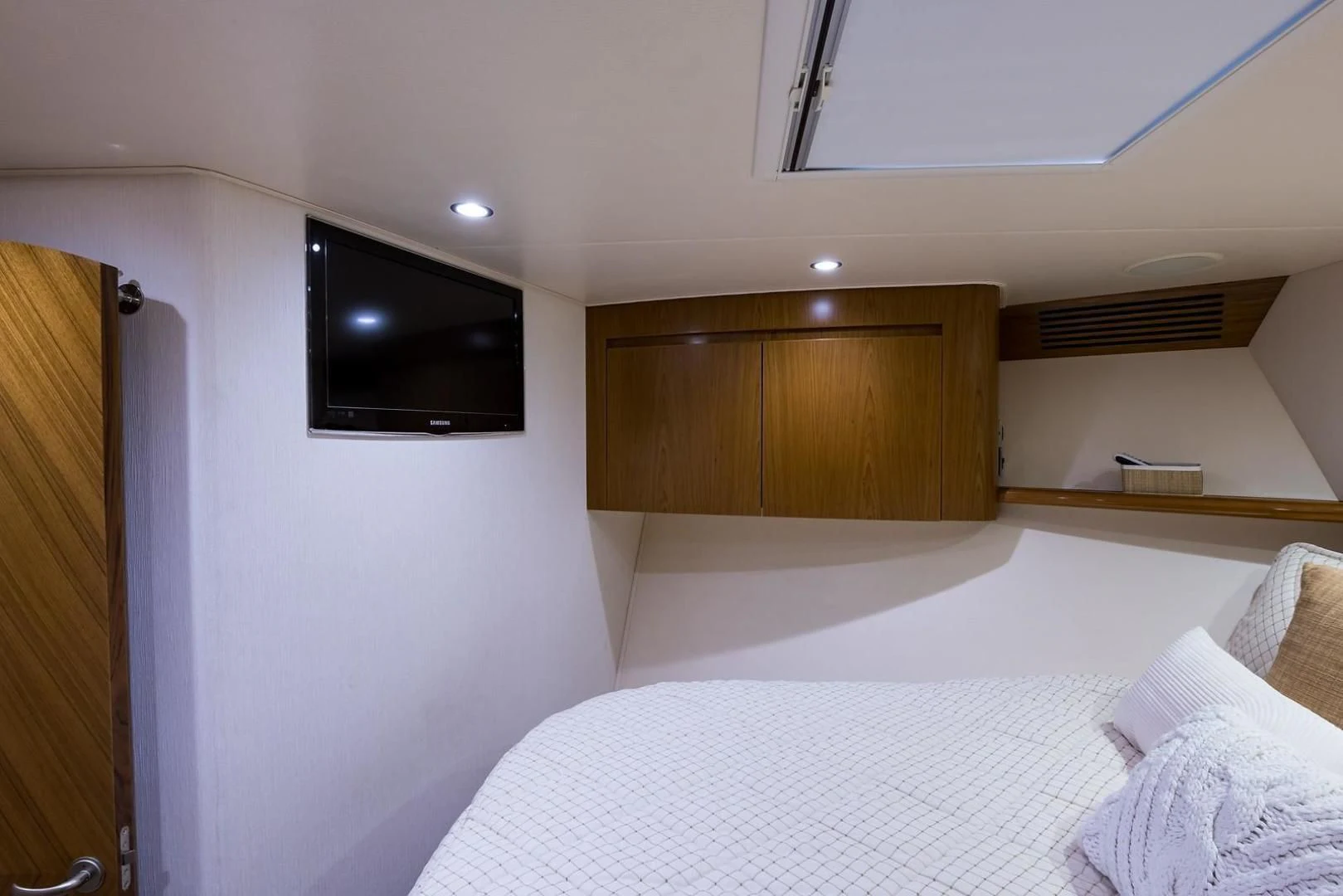 a bedroom with a bed and tv aboard LAST CALL Yacht for Sale