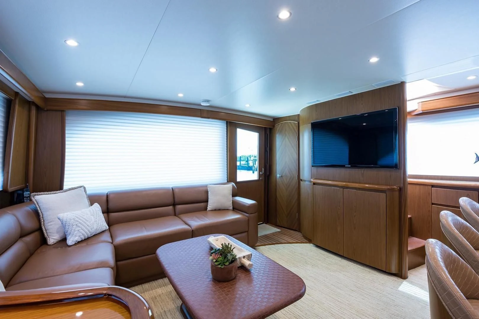 a living room with a couch and a television aboard LAST CALL Yacht for Sale