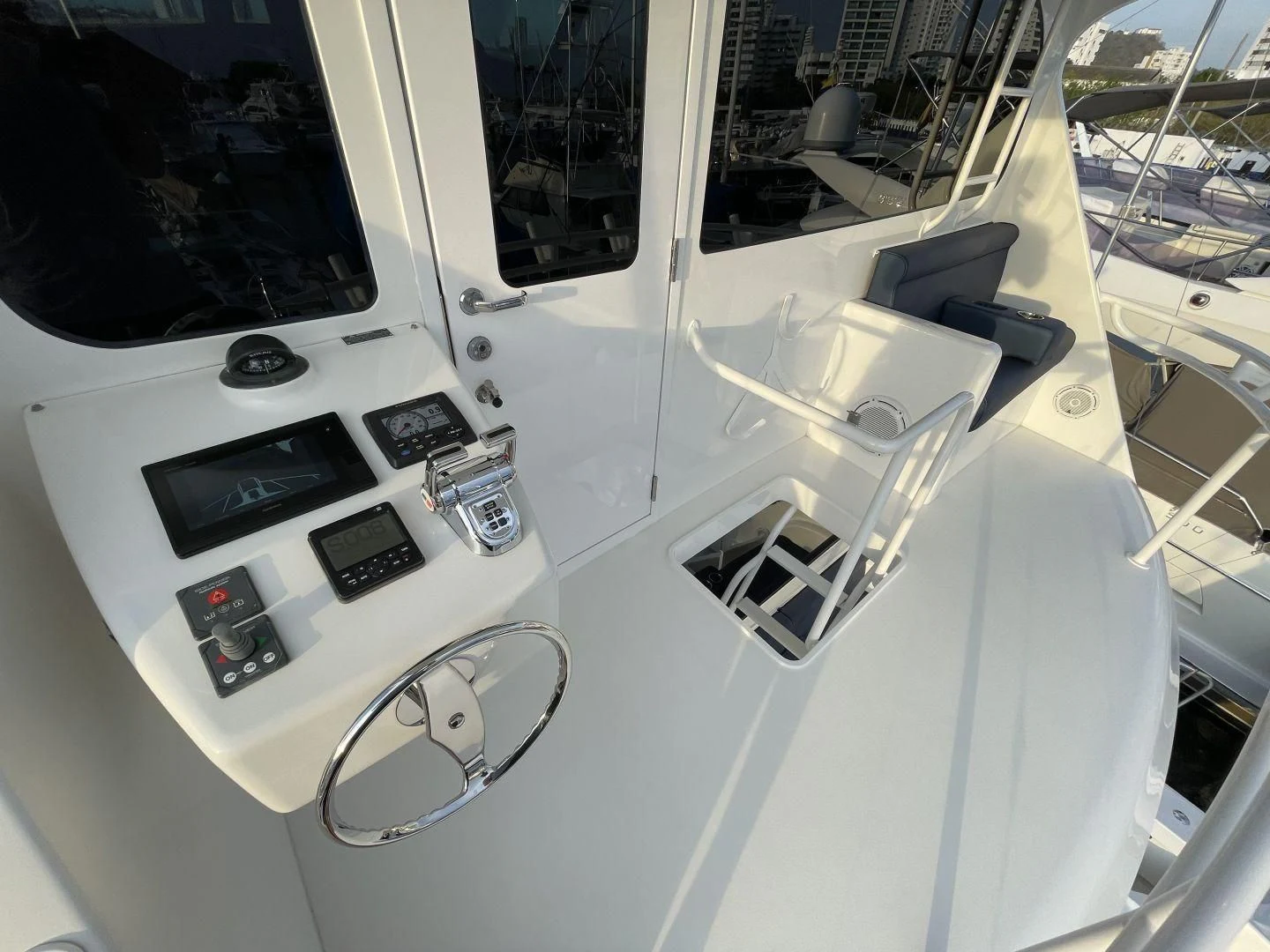a white machine with buttons and a steering wheel aboard LAST CALL Yacht for Sale