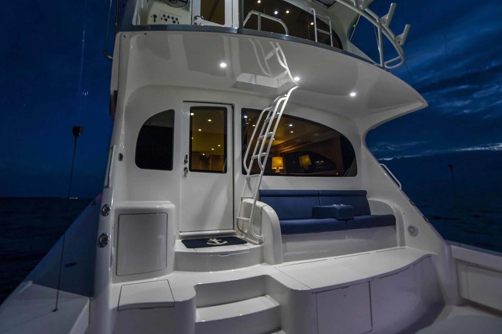 a white boat on a body of water aboard LAST CALL Yacht for Sale