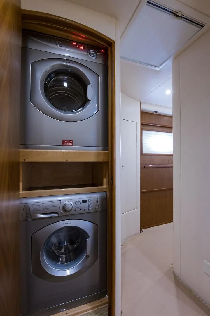a washer and dryer in a room aboard LAST CALL Yacht for Sale