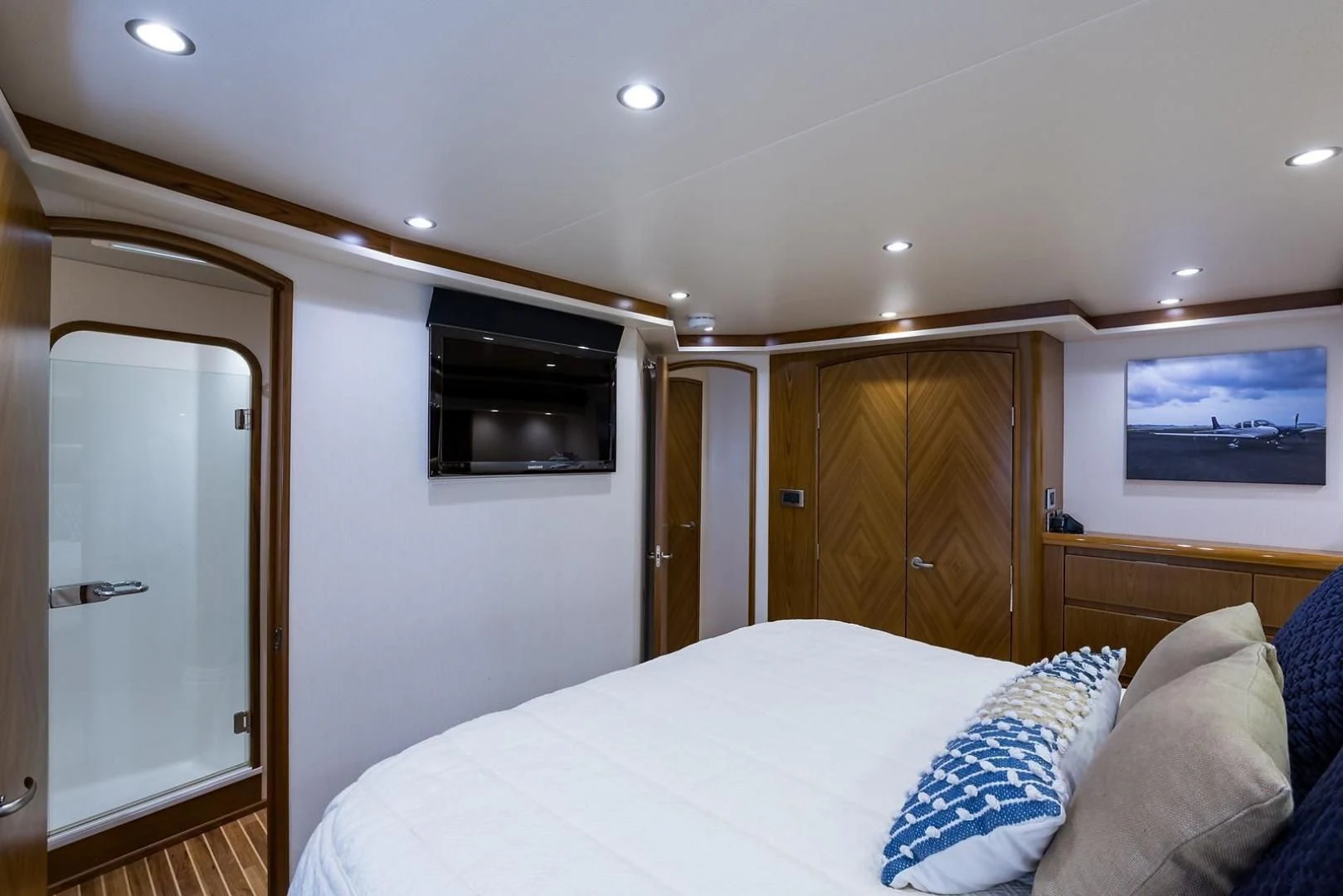 a bedroom with a bed and television aboard LAST CALL Yacht for Sale