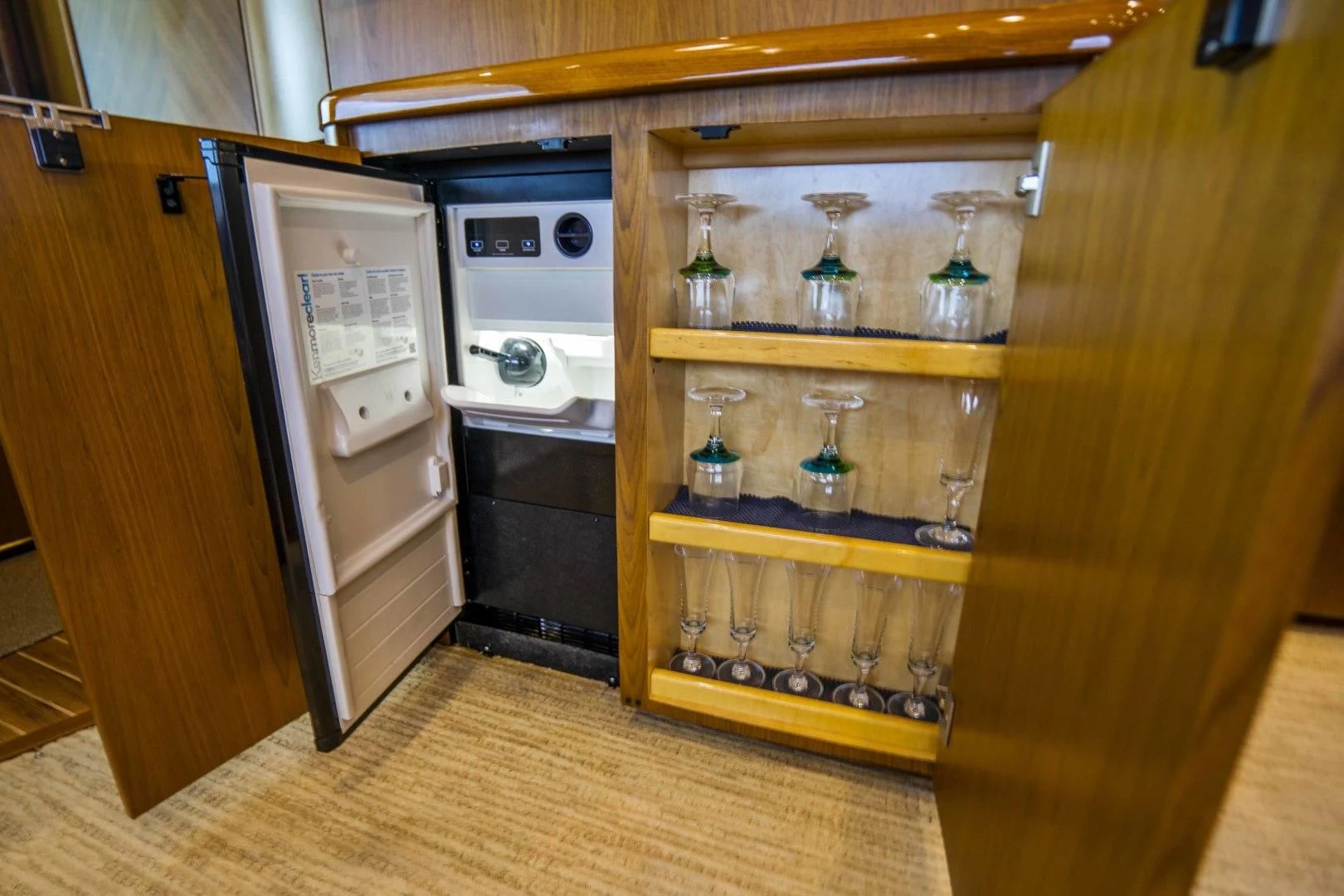 a kitchen with a refrigerator and cabinets aboard LAST CALL Yacht for Sale