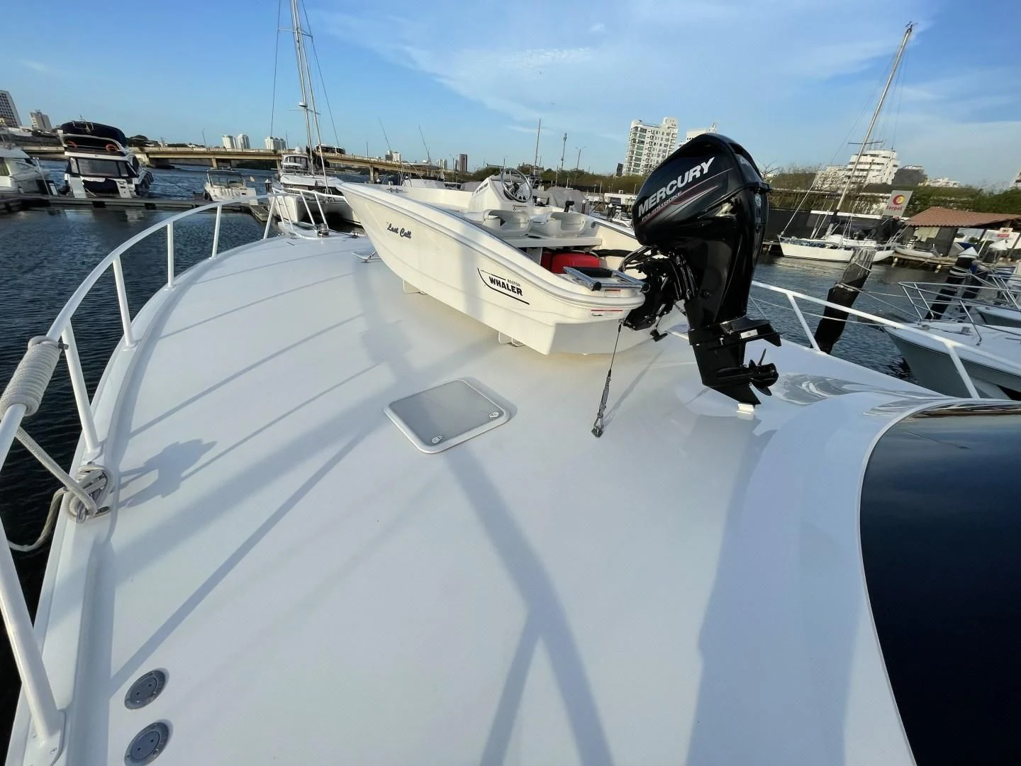 a white boat with a black steering wheel and a black steering wheel aboard LAST CALL Yacht for Sale