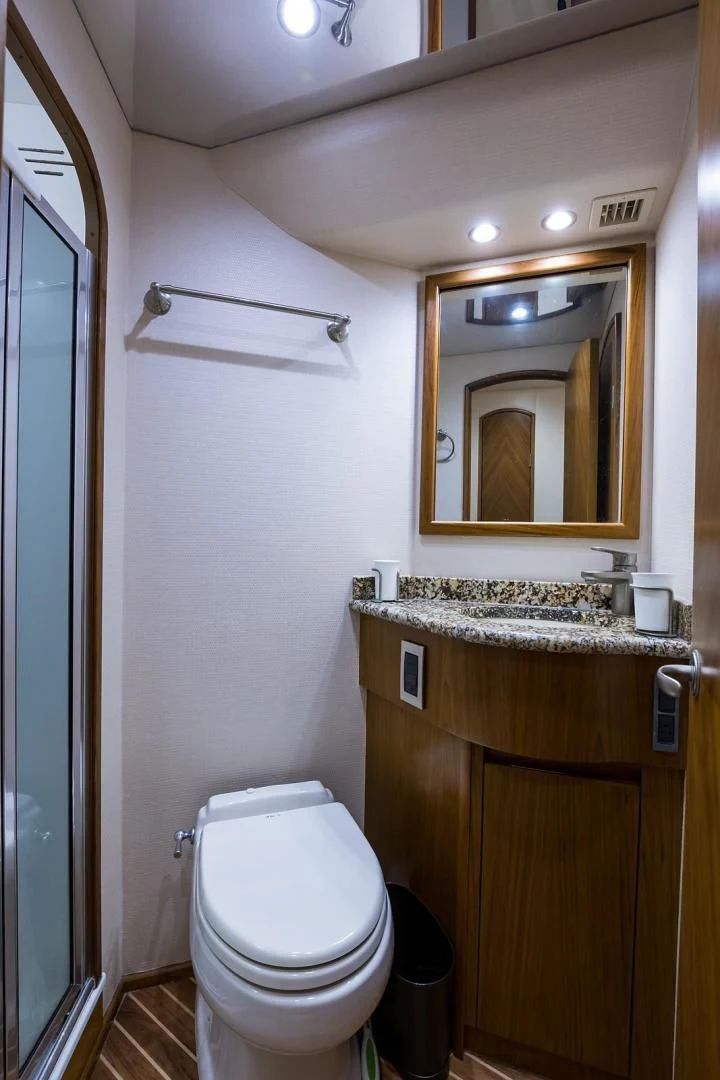 a bathroom with a toilet and a sink aboard LAST CALL Yacht for Sale