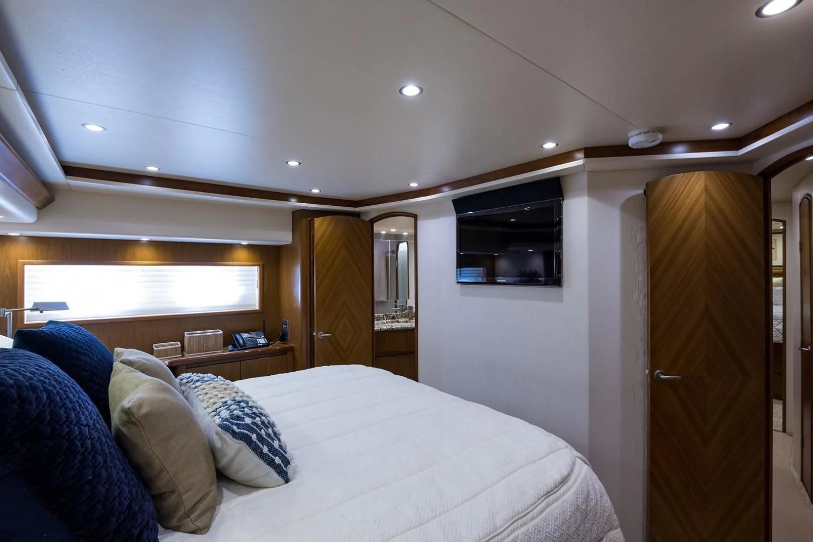 a bedroom with a bed and a television aboard LAST CALL Yacht for Sale