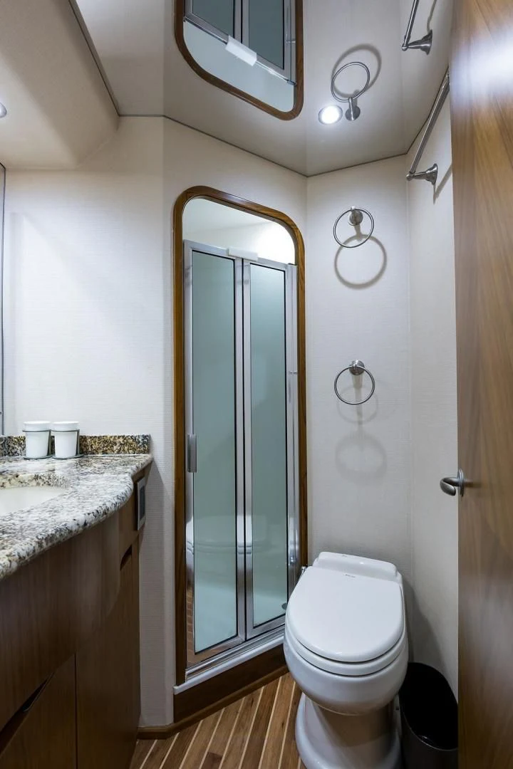 a bathroom with a glass shower door aboard LAST CALL Yacht for Sale