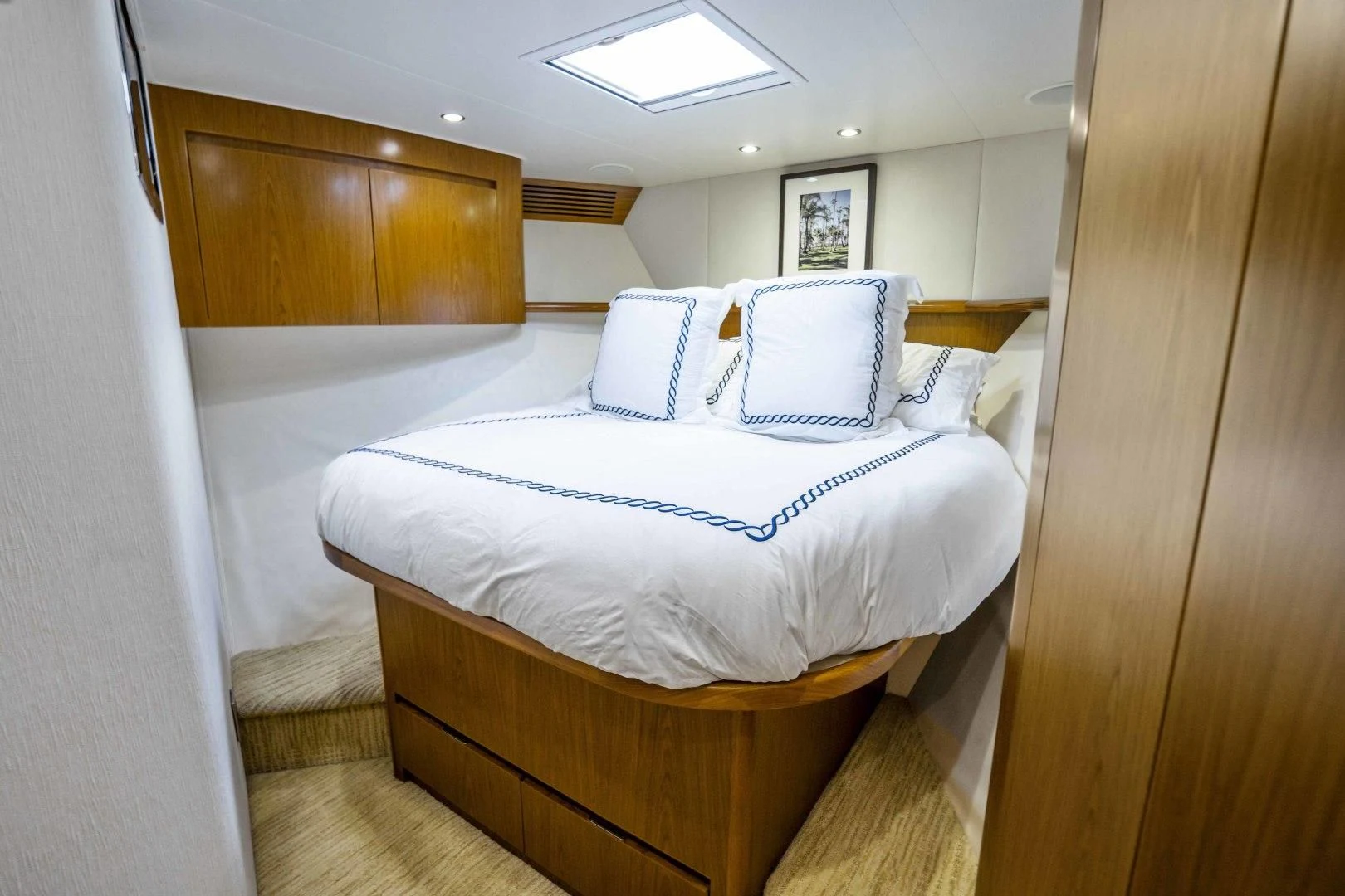 a room with a bed and a wood cabinet aboard LAST CALL Yacht for Sale