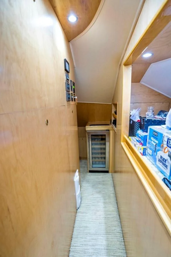 a hallway with a door and a cart with boxes on it aboard LAST CALL Yacht for Sale