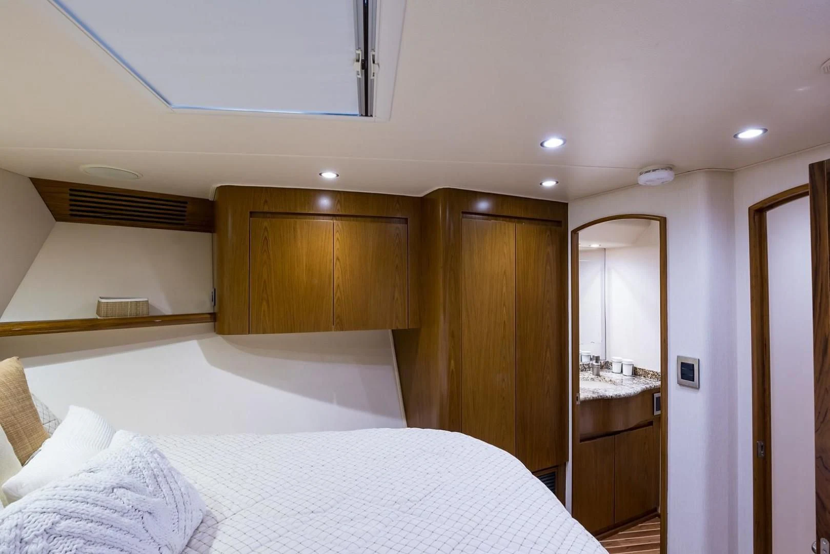 a bedroom with a bed and a sink aboard LAST CALL Yacht for Sale