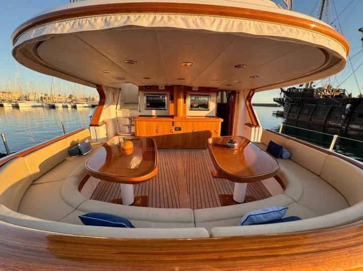 a boat with a table and chairs aboard BINZIYAD Yacht for Sale
