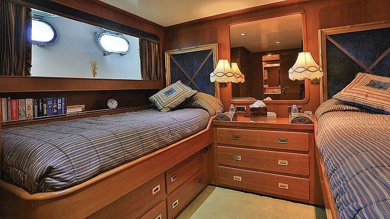 a bedroom with a bed and a dresser aboard NORDIC STAR Yacht for Sale