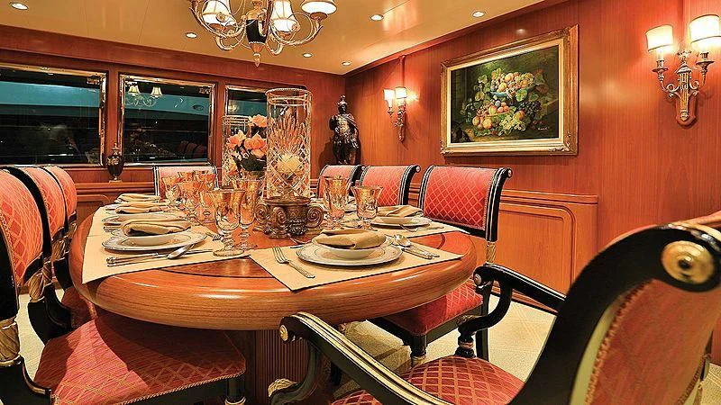 a dining table set with plates and glasses aboard NORDIC STAR Yacht for Sale