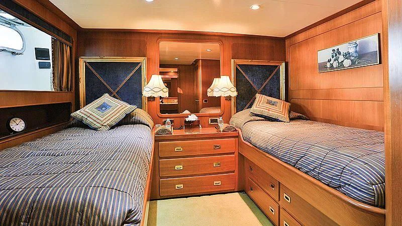 a bedroom with a bed and a dresser aboard NORDIC STAR Yacht for Sale