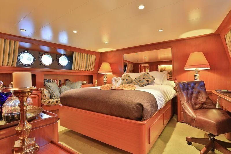 a bedroom with a bed and a chair aboard NORDIC STAR Yacht for Sale