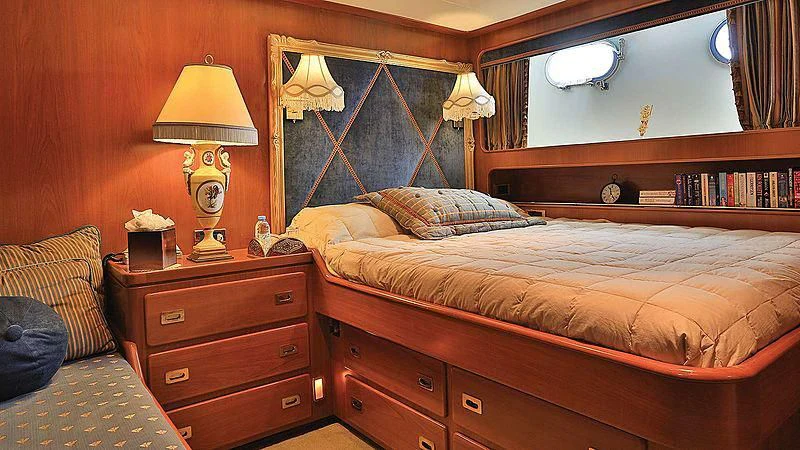 a bedroom with a bed and a lamp aboard NORDIC STAR Yacht for Sale