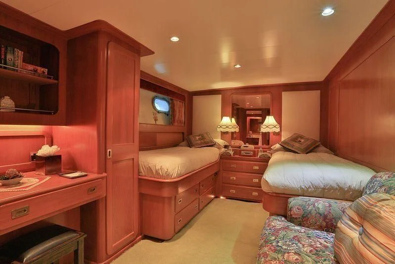 a bedroom with a bed and a desk aboard NORDIC STAR Yacht for Sale
