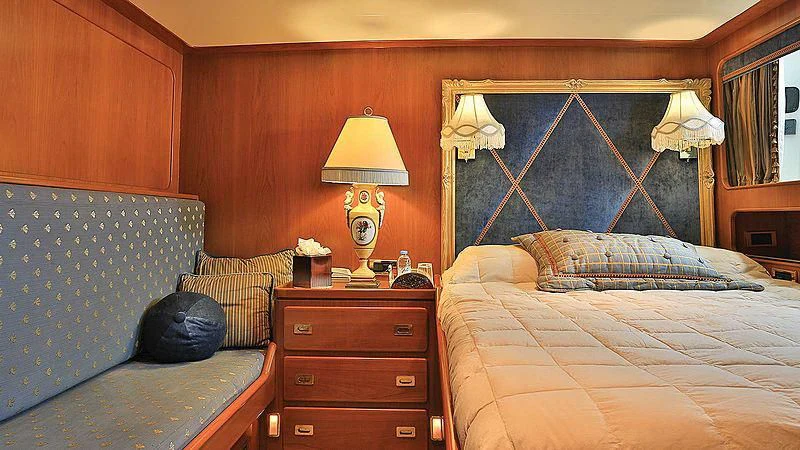 a bedroom with a bed and a lamp aboard NORDIC STAR Yacht for Sale