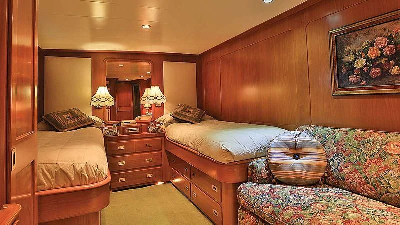 a room with a bed and a dresser aboard NORDIC STAR Yacht for Sale