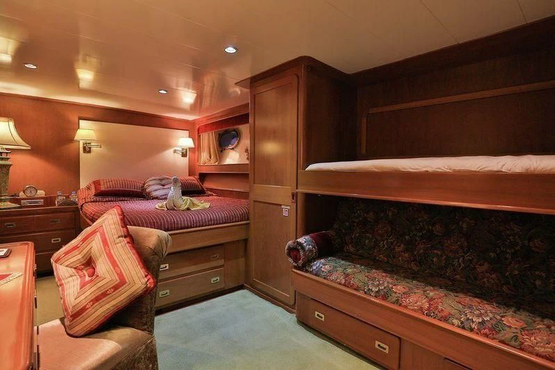 a room with a bed and a dresser aboard NORDIC STAR Yacht for Sale