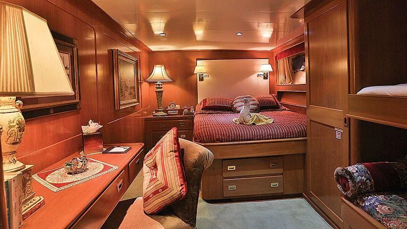a bedroom with a bed and a desk aboard NORDIC STAR Yacht for Sale