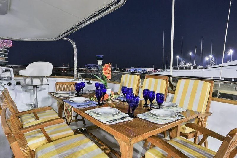 a table with plates and flowers on it aboard NORDIC STAR Yacht for Sale
