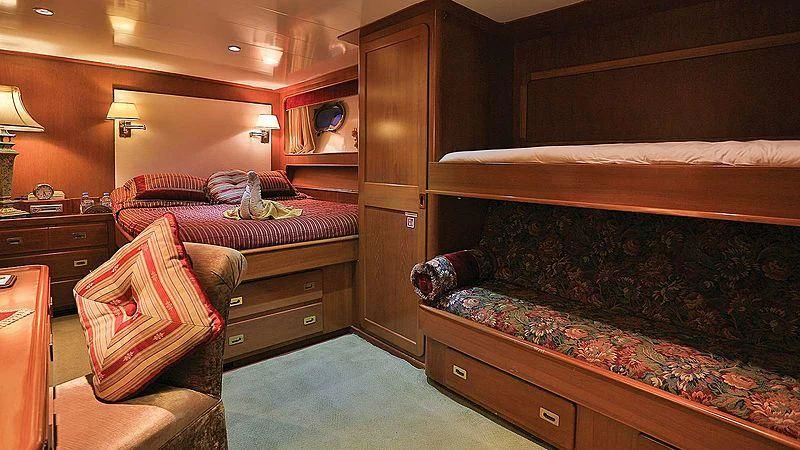 a room with a bed and a dresser aboard NORDIC STAR Yacht for Sale