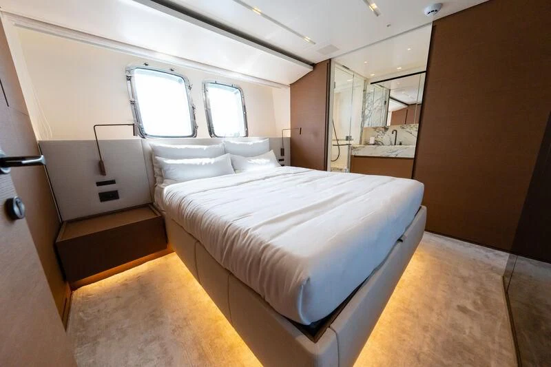 a room with a bed and a window aboard DA MOON Yacht for Sale
