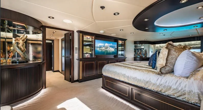 a large room with a couch and a tv aboard GRADE I Yacht for Charter