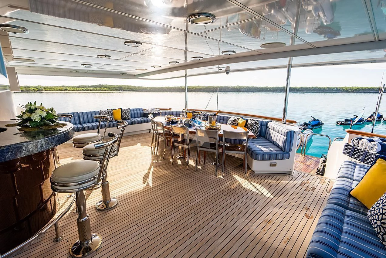 a room with a table chairs and tables aboard GRADE I Yacht for Charter
